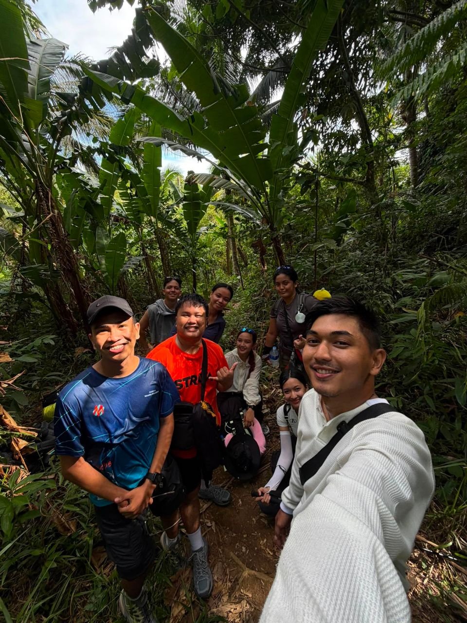 Hiking group posing together on the forest trail